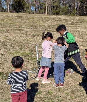 Young kids gathered around the rocket launcher