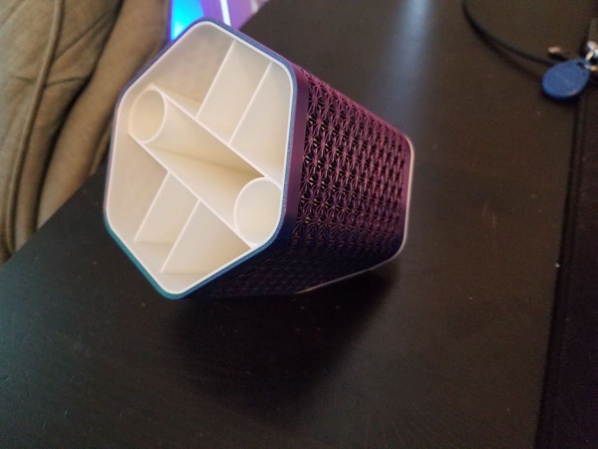 3D printed hexagonal pen holder with intricate lattice pattern