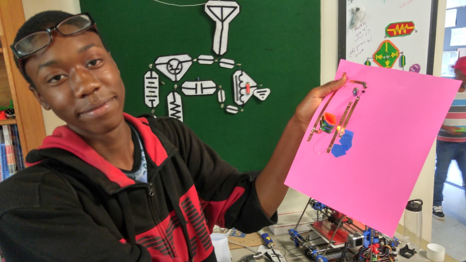 Student building paper circuit